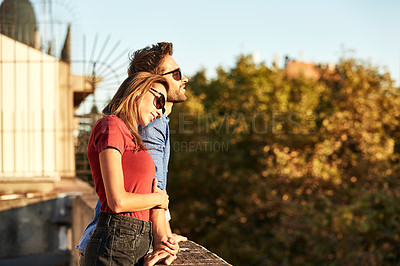 Buy stock photo Shot of an affectionate young couple exploring a foreign city