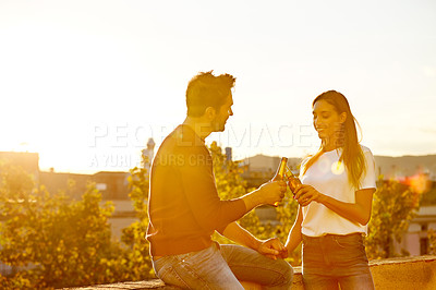 Buy stock photo Shot of a couple having drinks while on a rooftop date