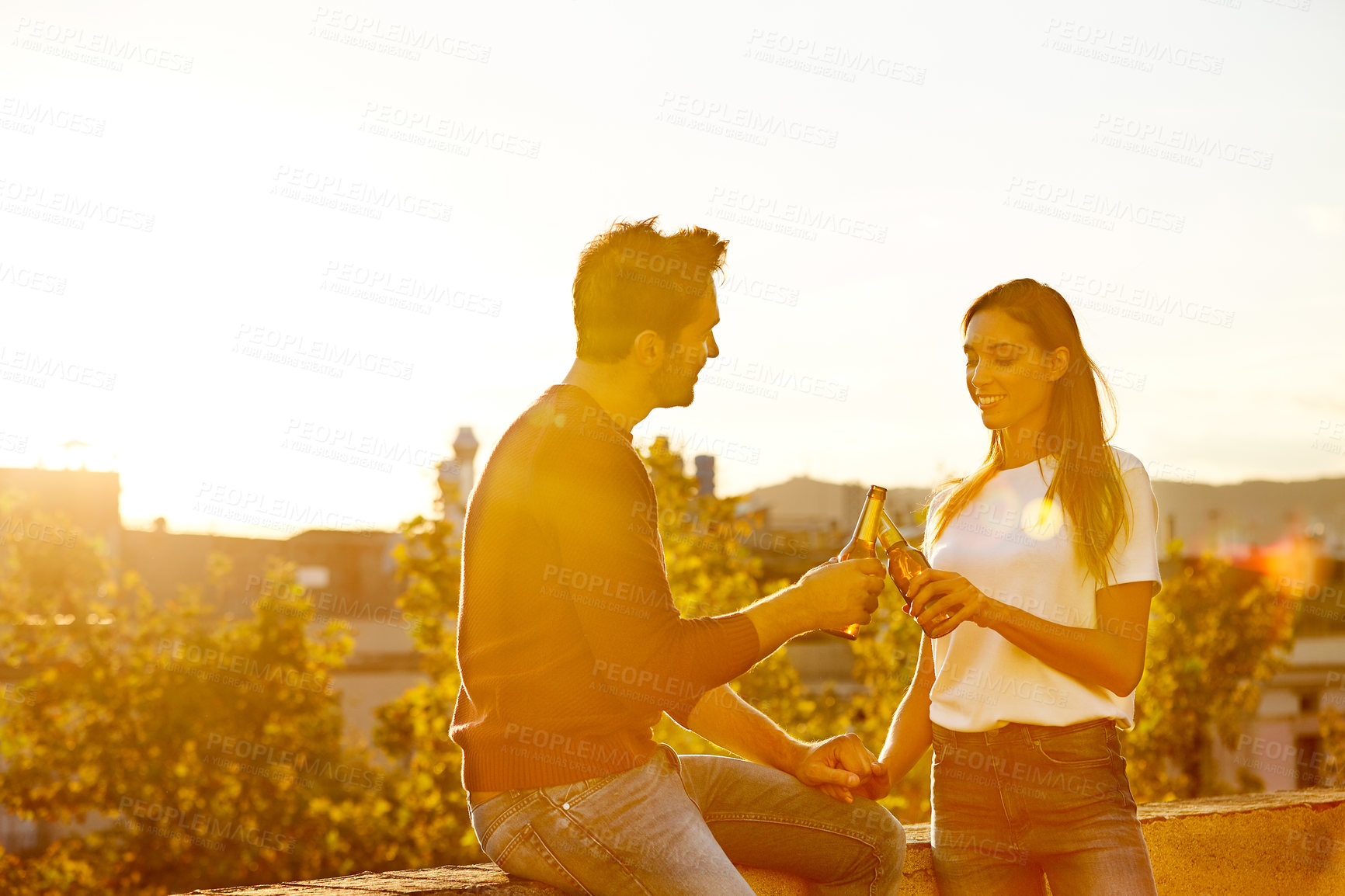 Buy stock photo Shot of a couple having drinks while on a rooftop date