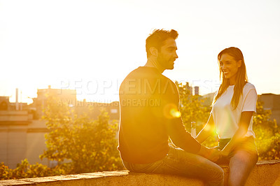 Buy stock photo Shot of a couple out on a rooftop for their date