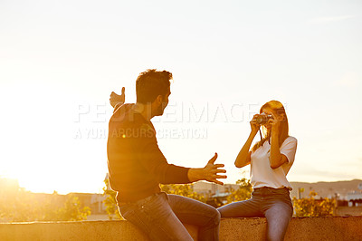 Buy stock photo Shot of a couple taking pictures while out on a date