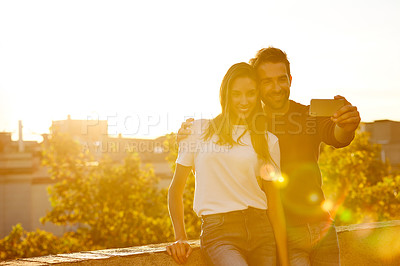 Buy stock photo Shot of a couple taking pictures while out on a date