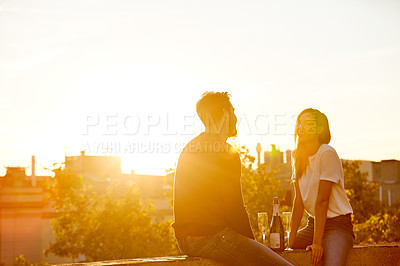 Buy stock photo Shot of a couple having drinks while on a rooftop date