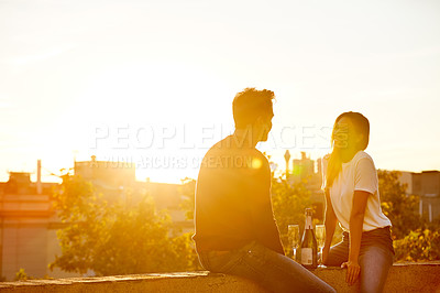 Buy stock photo Shot of a couple having champagne while on a rooftop date