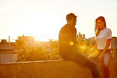 Buy stock photo Shot of a couple having champagne while on a rooftop date