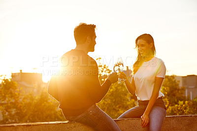 Buy stock photo Shot of a couple having champagne while on a rooftop date
