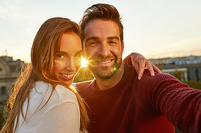 Buy stock photo Shot of a couple out on a rooftop for their date