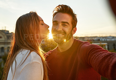 Buy stock photo Shot of a couple out on a rooftop for their date