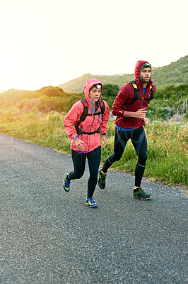 Buy stock photo Full length shot of a young couple out for a morning run