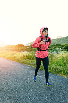 Buy stock photo Full length shot of an attractive young female athlete out for a morning run