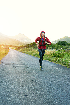Buy stock photo Full length shot of a handsome young male athlete out for a morning run