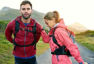 Buy stock photo Cropped shot of a young couple warming up before their morning run
