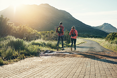 Buy stock photo Rearview shot of an unrecognizable young couple out for a morning run