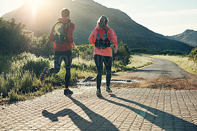 Buy stock photo Rearview shot of an unrecognizable young couple out for a morning run
