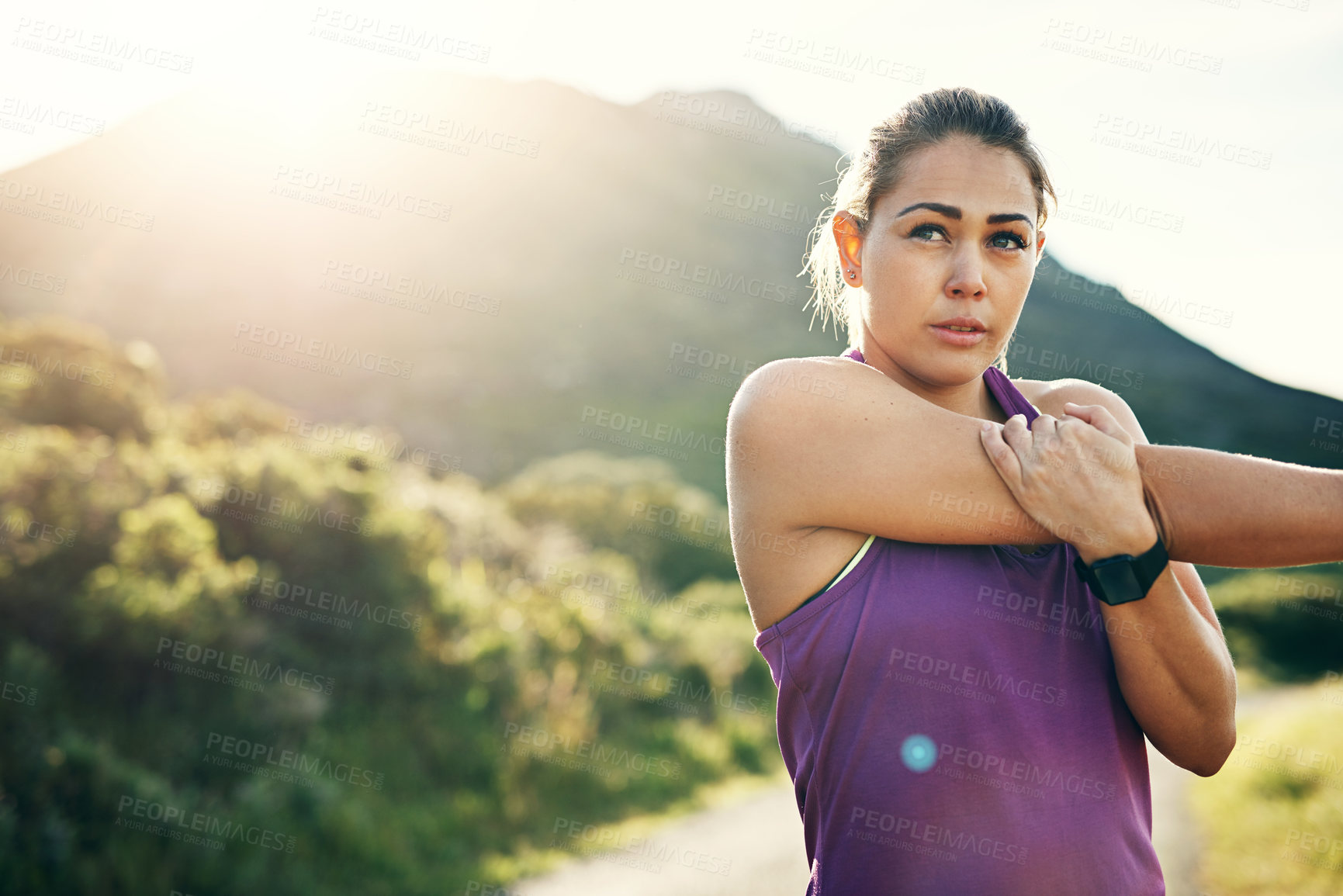 Buy stock photo Cropped shot of an attractive young female athlete stretching before her morning run