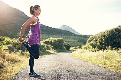 Buy stock photo Full length shot of an attractive young female athlete stretching before her morning run