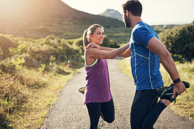 Buy stock photo Cropped shot of a young couple warming up before their morning run