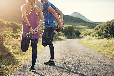 Buy stock photo Rearview shot of an unrecognizable young couple warming up before their morning run