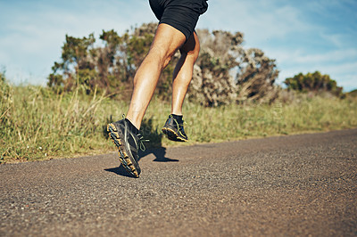 Buy stock photo Cropped shot of an unrecognizable young man out for his morning run