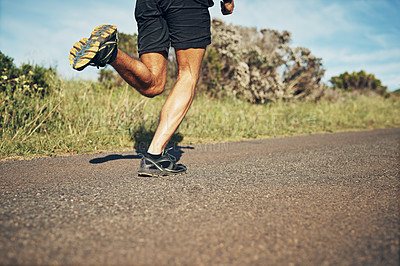 Buy stock photo Cropped shot of an unrecognizable young man out for his morning run
