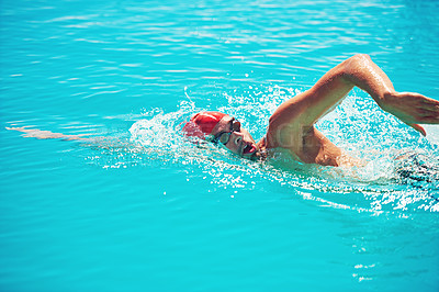 Buy stock photo High angle shot of a handsome young male swimmer swimming in a pool