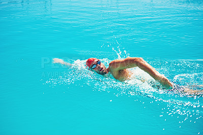 Buy stock photo High angle shot of a handsome young male swimmer swimming in a pool