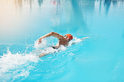Buy stock photo High angle shot of a handsome young male swimmer swimming in a pool