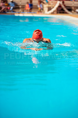 Buy stock photo Shot of an unrecognizable young male swimmer doing breaststroke in a swimming pool