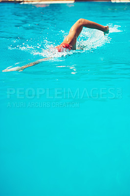 Buy stock photo High angle shot of an unrecognizable young male swimmer doing freestyle in a swimming pool