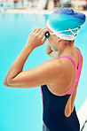 Adjusting her goggles