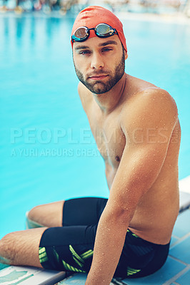Buy stock photo Cropped portrait of a handsome young male swimmer sitting on the side of a pool