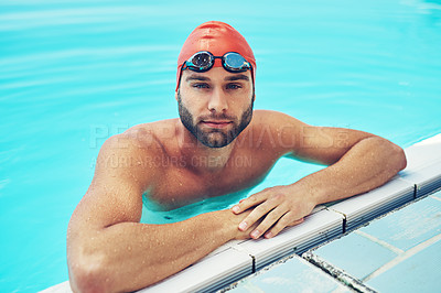 Buy stock photo High angle portrait of a handsome young male swimmer chilling in the swimming pool