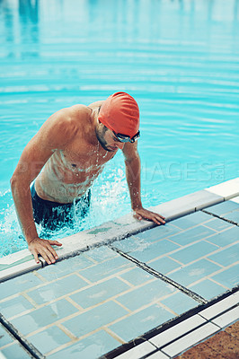 Buy stock photo High angle shot of a young male swimmer making his exit from the swimming pool