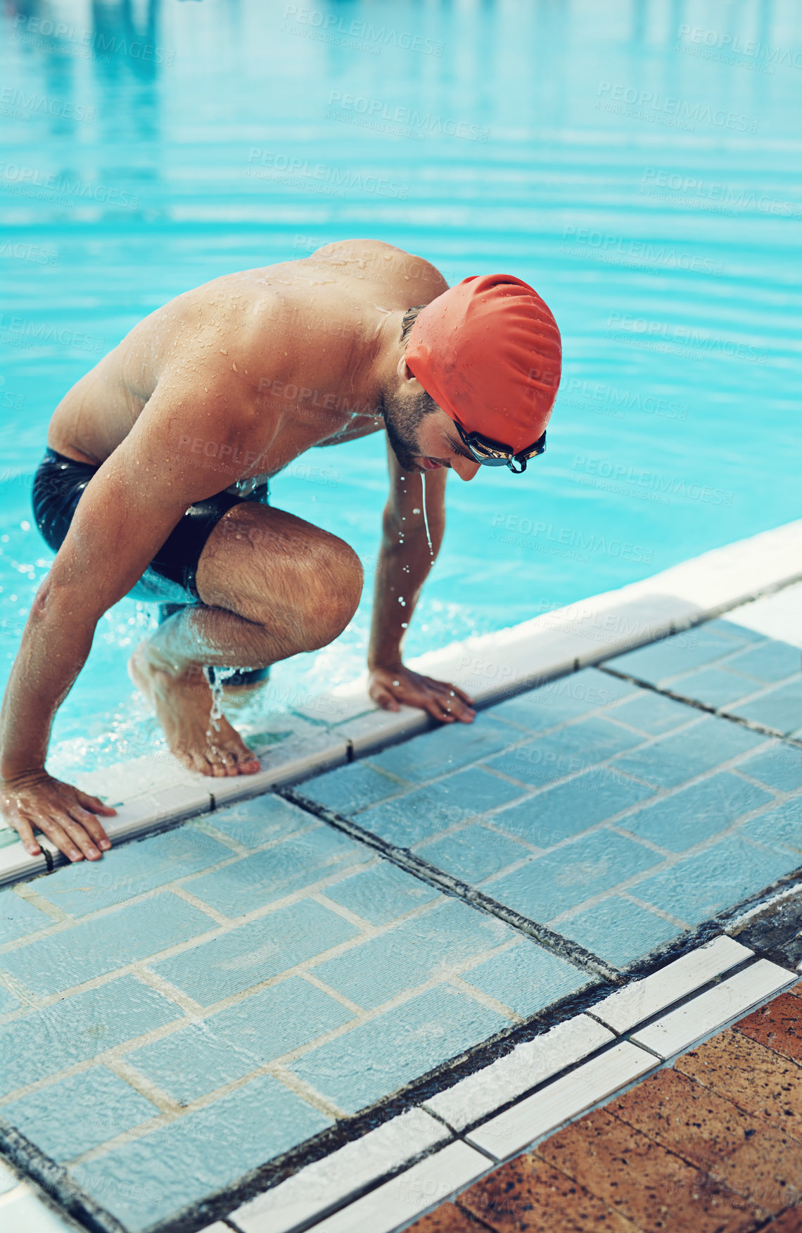 Buy stock photo High angle shot of a young male swimmer making his exit from the swimming pool