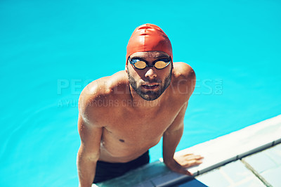 Buy stock photo High angle portrait of a handsome young male swimmer getting out of the pool