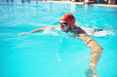 Buy stock photo High angle shot of a handsome young male swimmer floating in a swimming pool