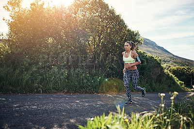 Buy stock photo Full length shot of an attractive young female athlete out for a morning run