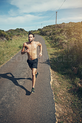 Buy stock photo High angle shot of a handsome young male athlete out for a morning run