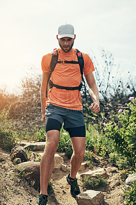 Buy stock photo Low angle shot of a handsome young male athlete out for a morning run