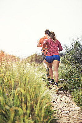 Buy stock photo Rearview shot of a young athletic couple out for their morning run