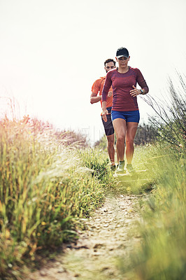 Buy stock photo Rearview shot of a young athletic couple out for their morning run