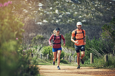 Buy stock photo Rearview shot of a young athletic couple out for their morning run