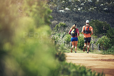 Buy stock photo Rearview shot of a young athletic couple out for their morning run