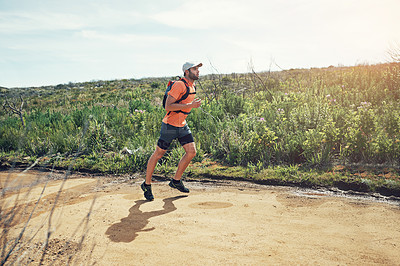Buy stock photo Full length shot of a handsome young male athlete out for a morning run