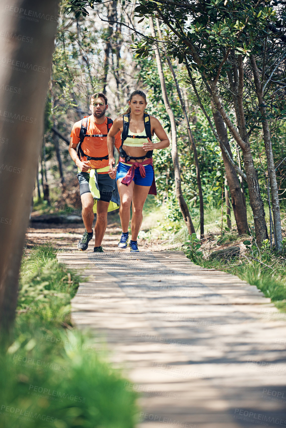 Buy stock photo Journey, outdoor and couple with backpack, running and physical activity with partner and wellness. Runner, fitness and people with endurance, training and exercise for health or cardio in nature