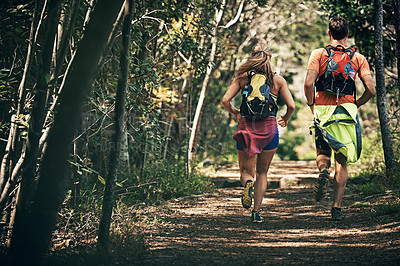 Buy stock photo Rearview shot of a young athletic couple out for their morning run