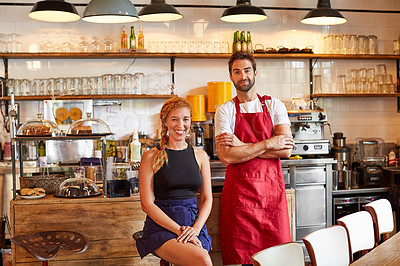 Buy stock photo Shot of a confident man and woman working together in a coffee shop