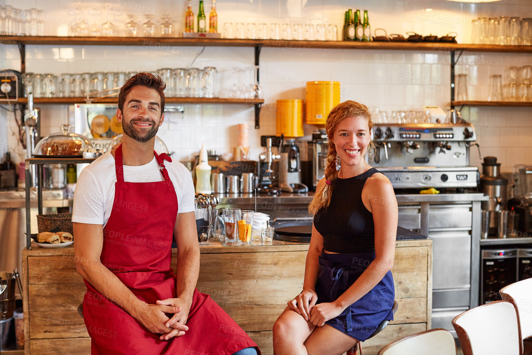Buy stock photo Shot of a confident man and woman working together in a coffee shop