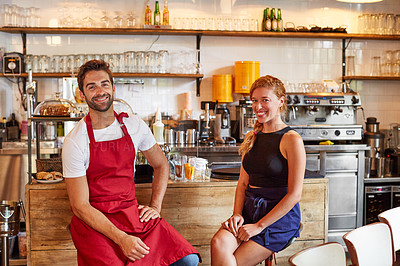 Buy stock photo Shot of a confident man and woman working together in a coffee shop
