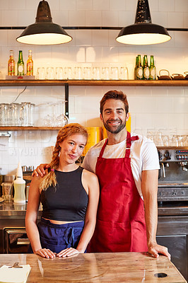 Buy stock photo Shot of a confident man and woman working together in a coffee shop